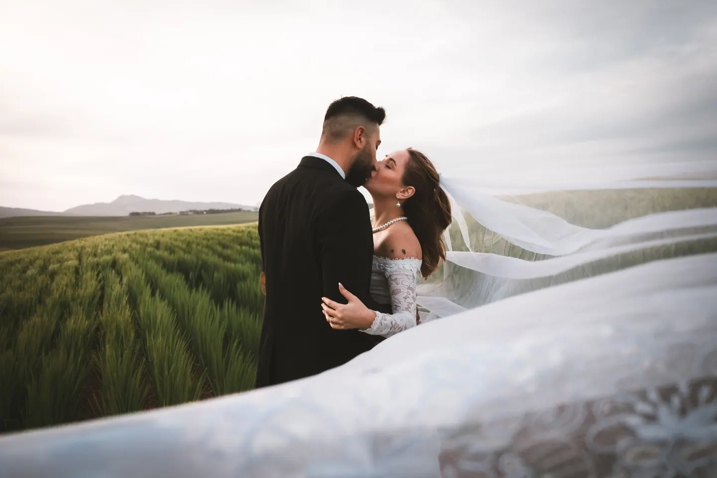A couple photographed together outdoors at golden hour